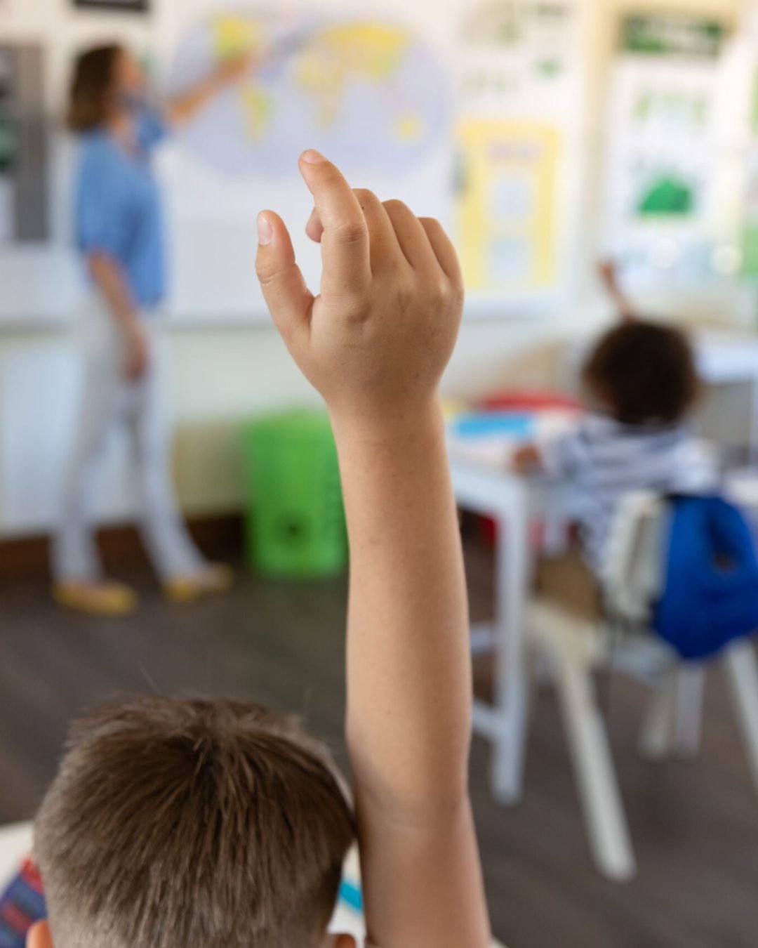 students-raising-hands-class-school-scaled.jpg
